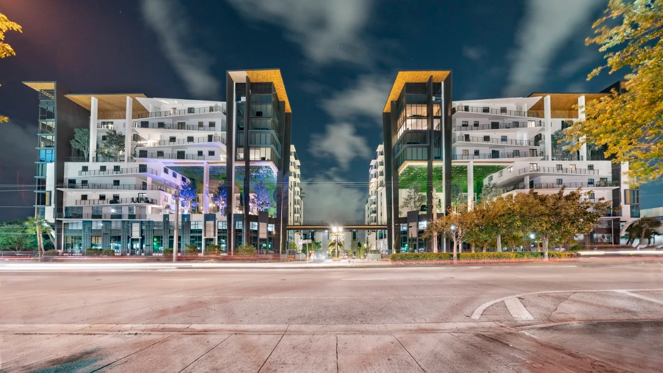 Envy Apartments residential building exterior at dusk